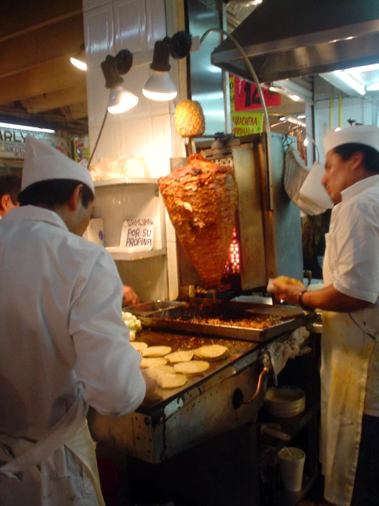 three chefs preparing food at an indoor restaurant