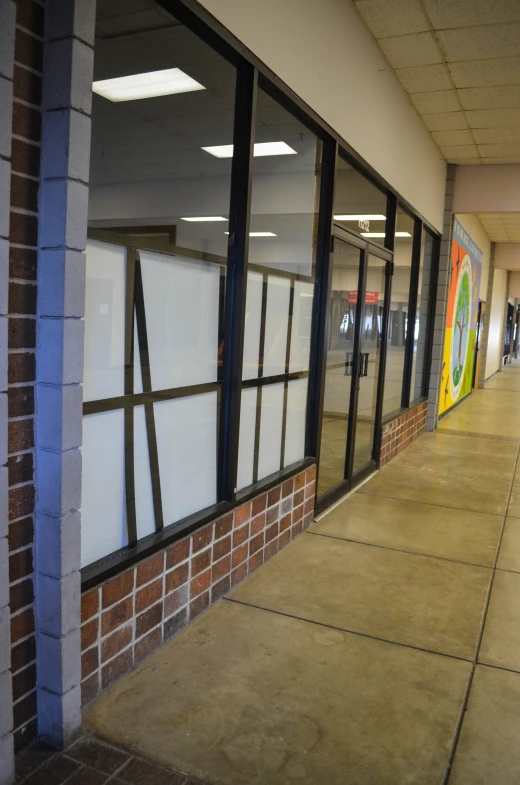 the entrance to a building has windows and lots of glass