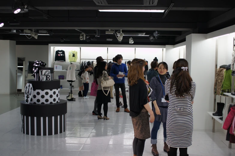 a group of people that are looking at some clothing