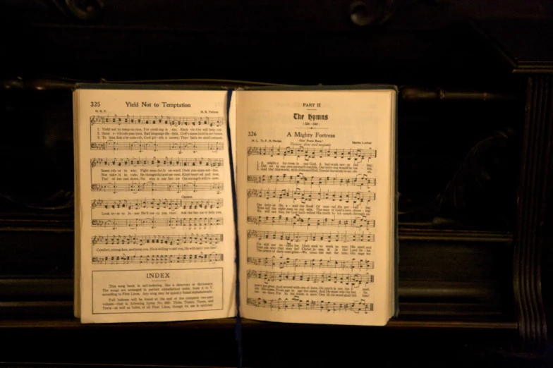 the pages of an old book are open to show musical notes
