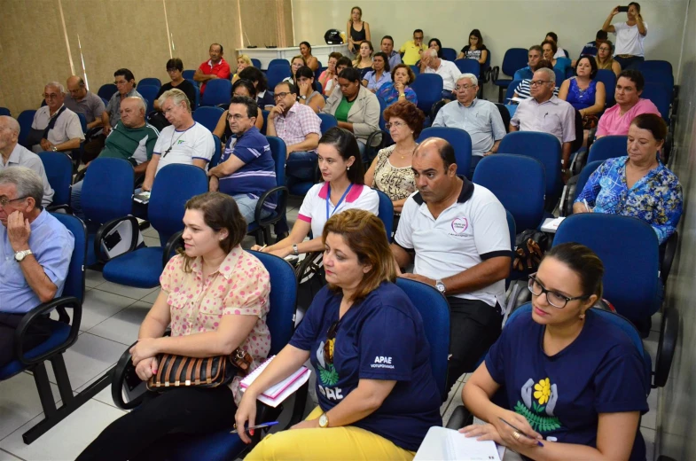 many people are seated in a lecture hall