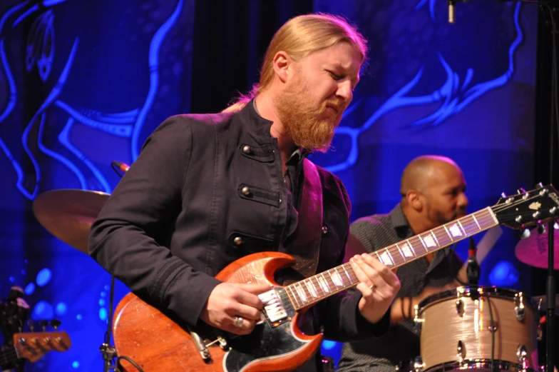 a guy playing an electric guitar on stage