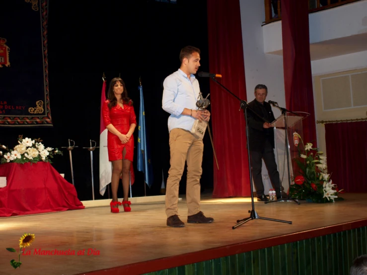 the man and woman are performing on stage