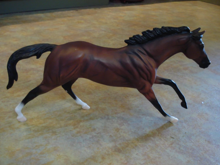 horse toy walking on tile floor in indoor environment