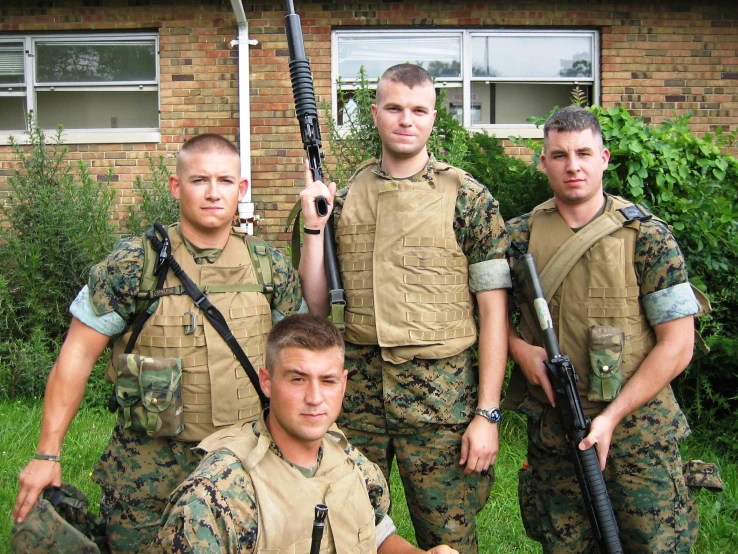 a group of men with guns and a helmet