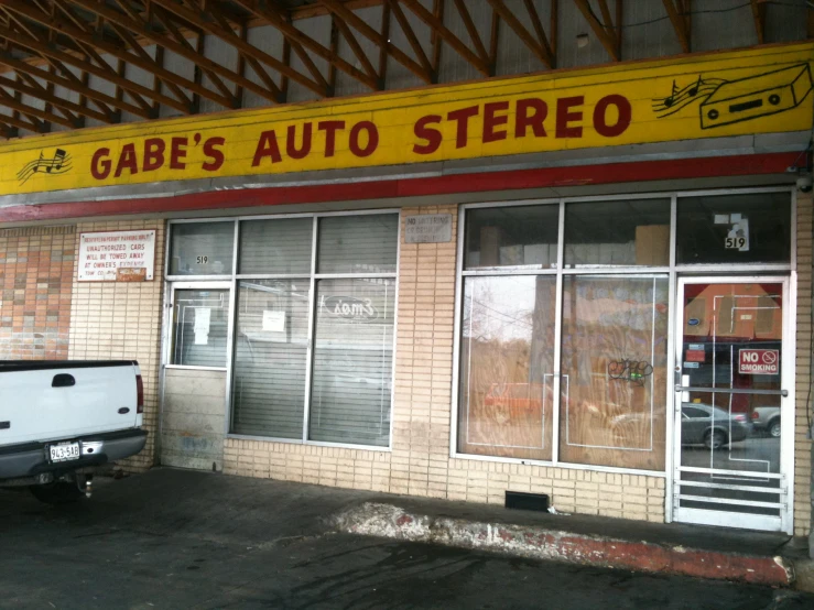 a car is parked outside of a auto stereo store