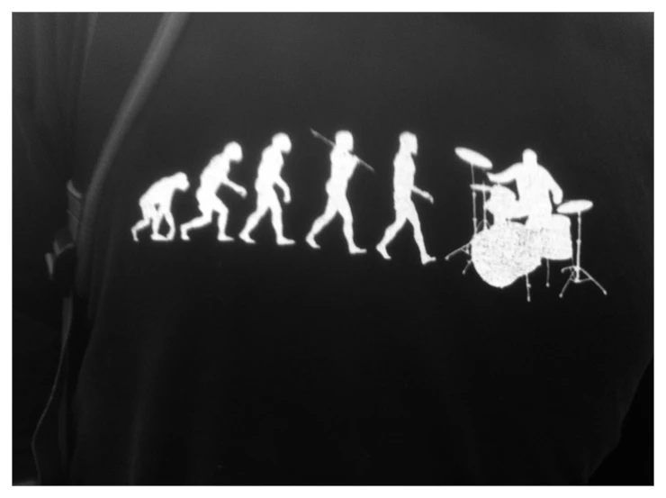 a group of people silhouetted against an image of a musical instrument