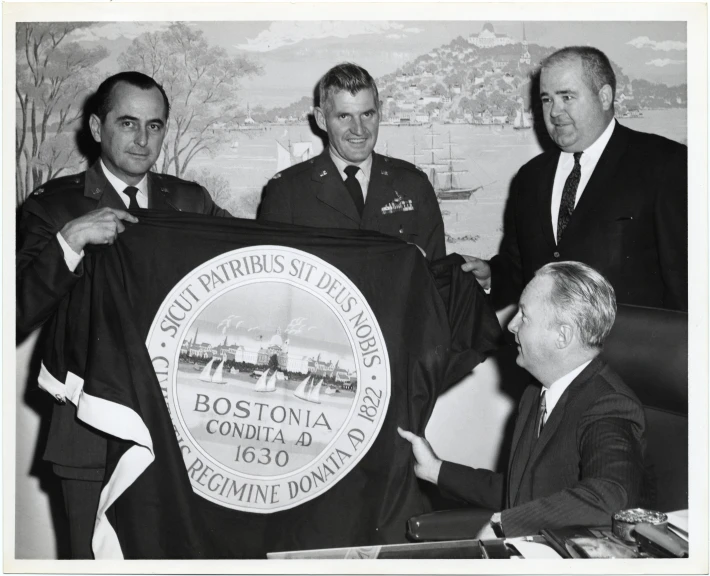 a group of men holding a black flag in front of them