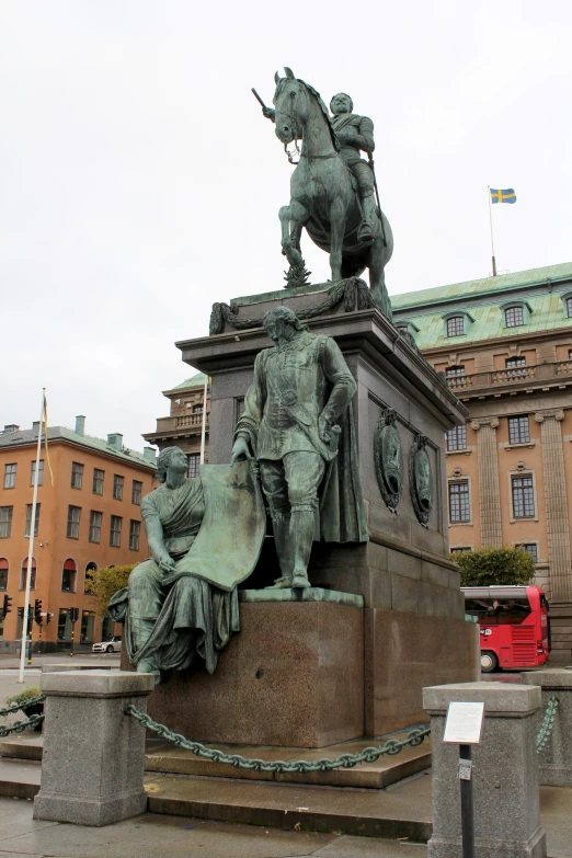 a statue of a man with a horse and other animals