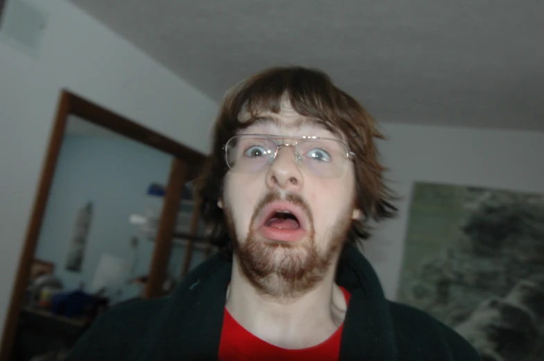 a guy making a shocked expression while wearing glasses