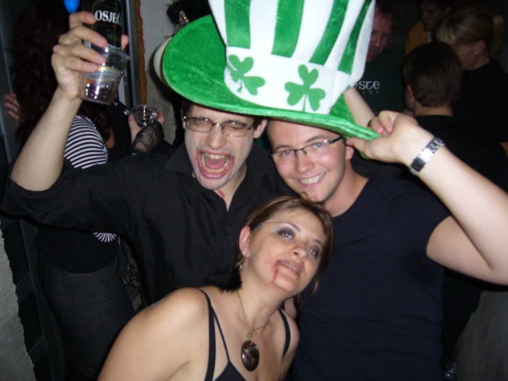 two men wearing green hats at a party