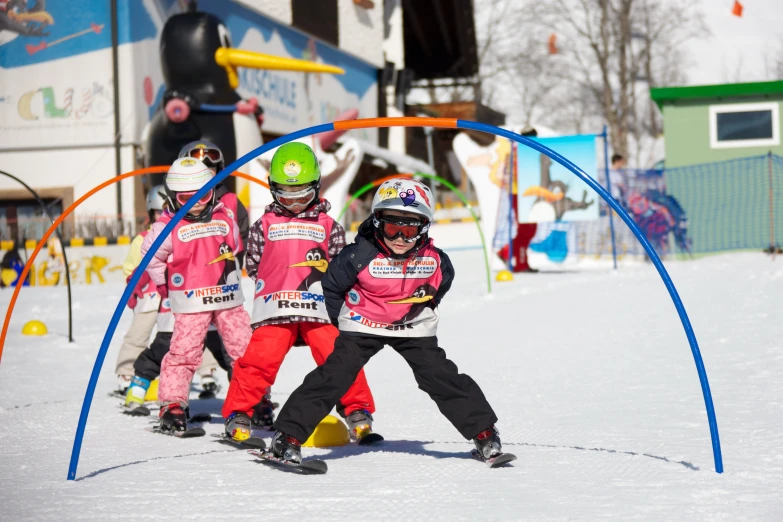 four children are in the snow and on skis