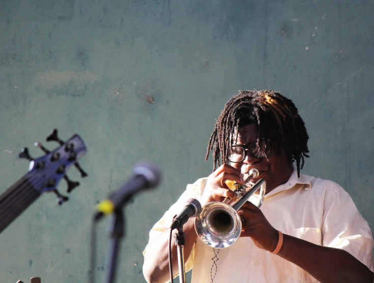 a man that is holding a trumpet in his hand