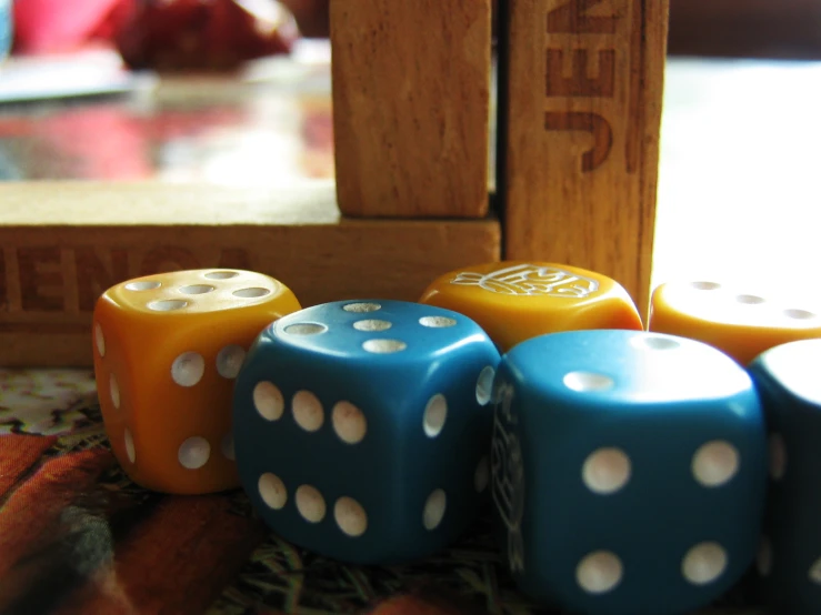 colorful dices are displayed near a po frame