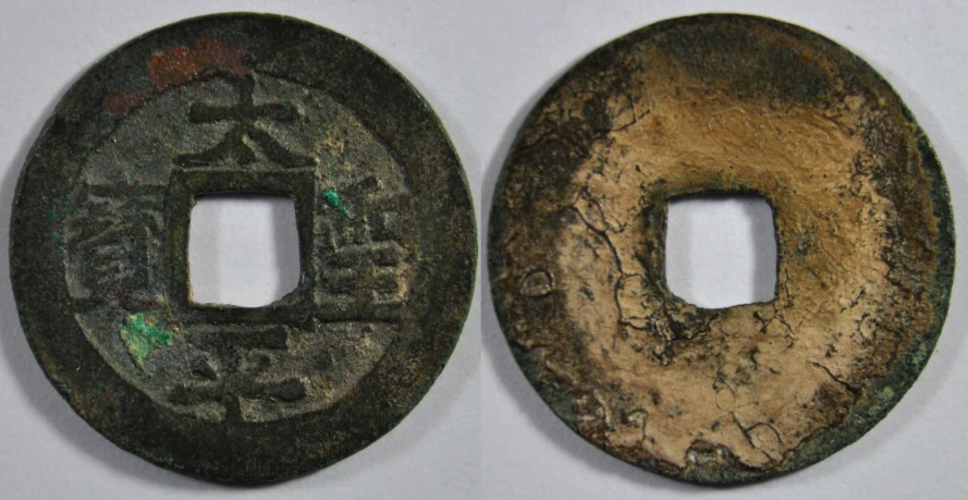 two old coins sitting on top of each other