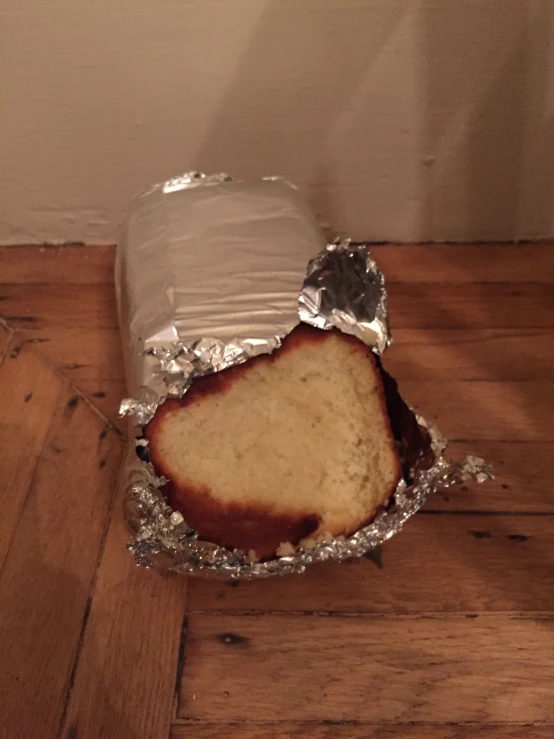 a slice of cake in tin foil on a table