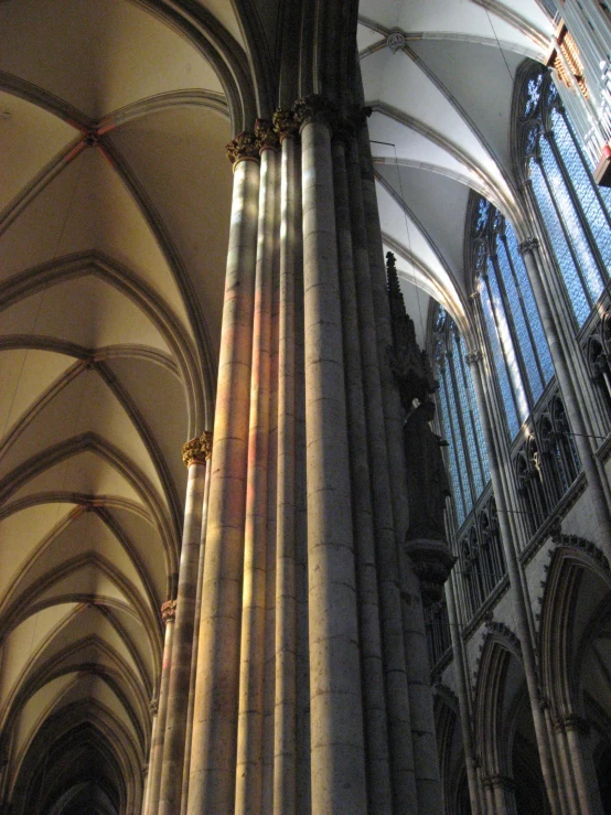 light streams through the arches of an gothic cathedral