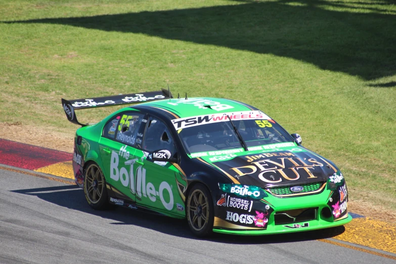 a race car driving down the road at the track