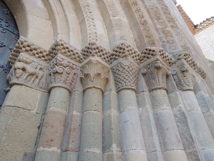 a close up of a building with a large stone wall