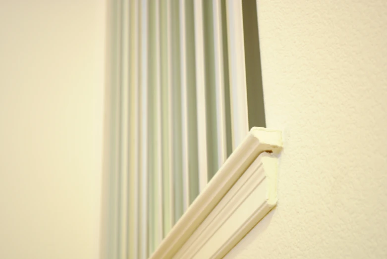 a corner s of a white window with grey lines