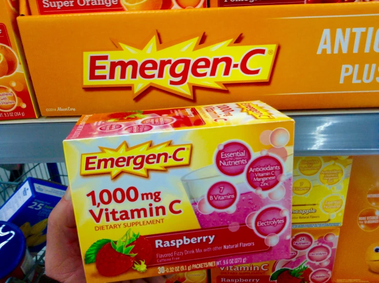 someone holding a box of emergen c with red berries inside