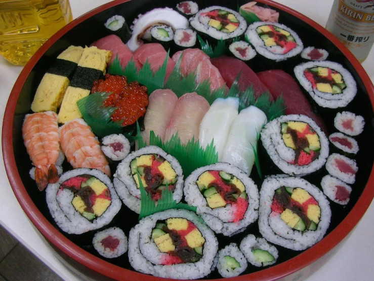 a platter of sushi with two chopsticks