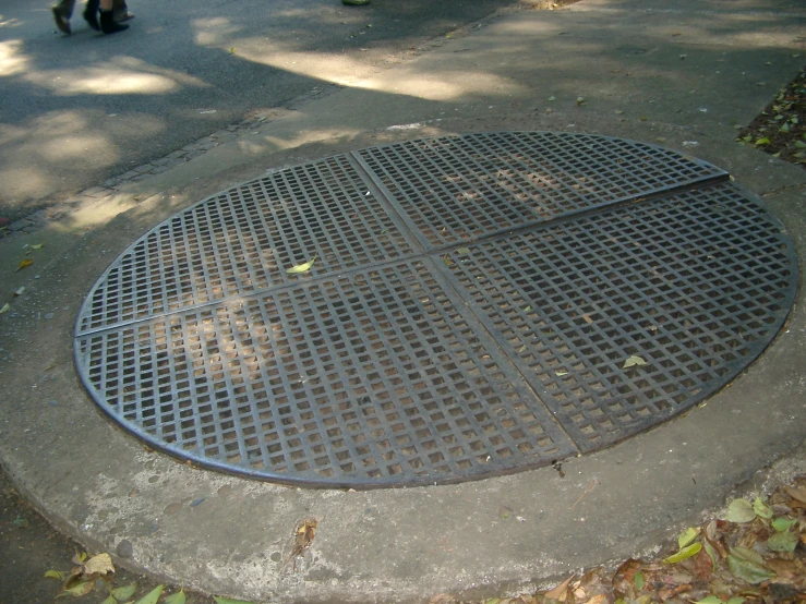 the floor drain drain is in a circular metal grate