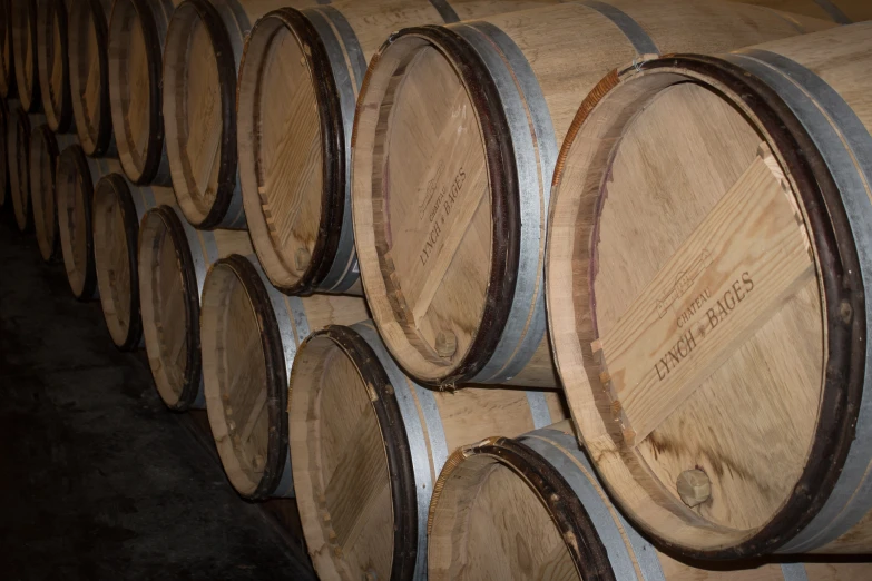 a bunch of wine barrels are lined up in a cellar