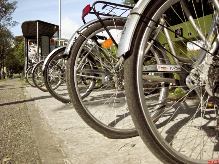 a row of bikes parked on a sidewalk