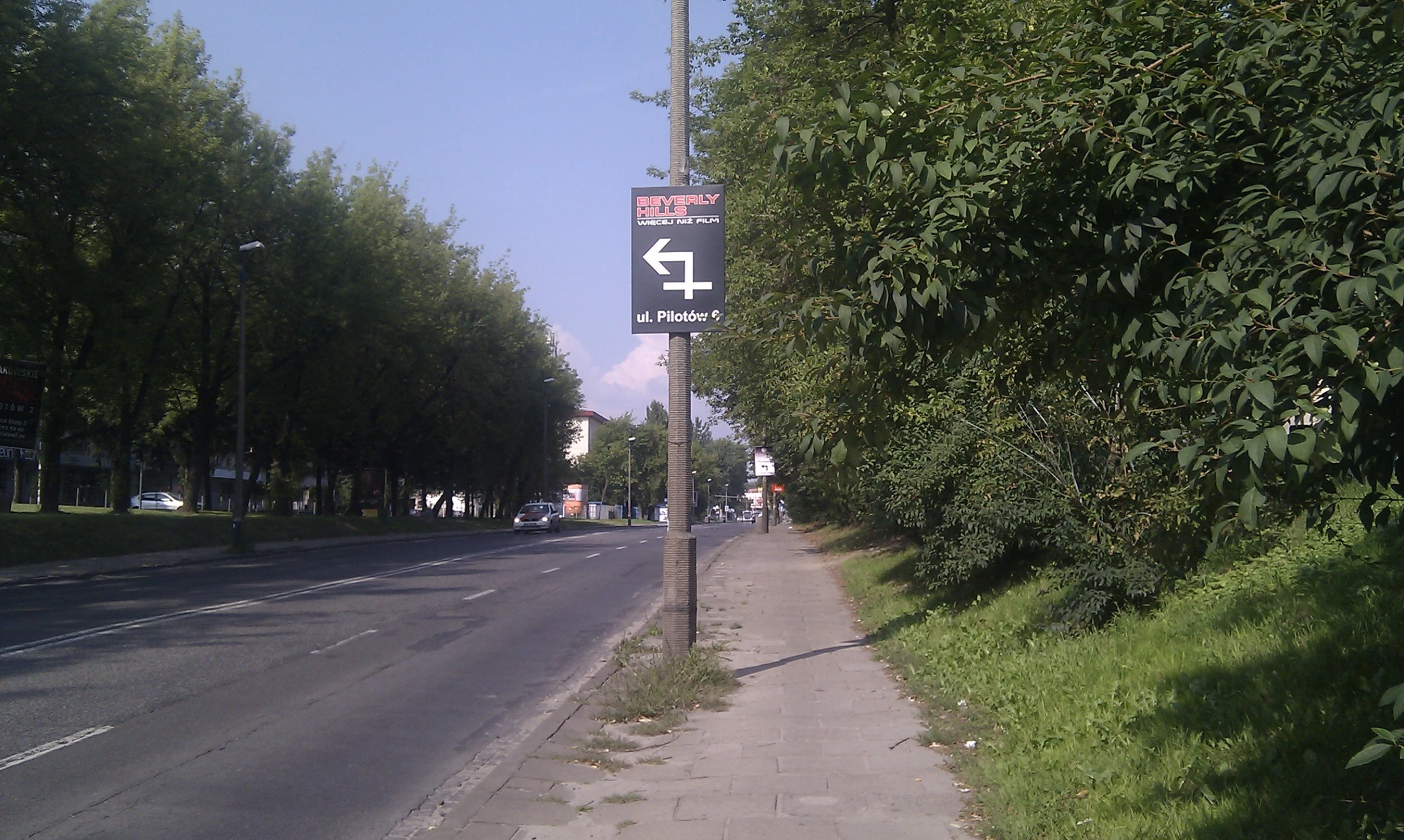 a street sign on the side of a road in a city