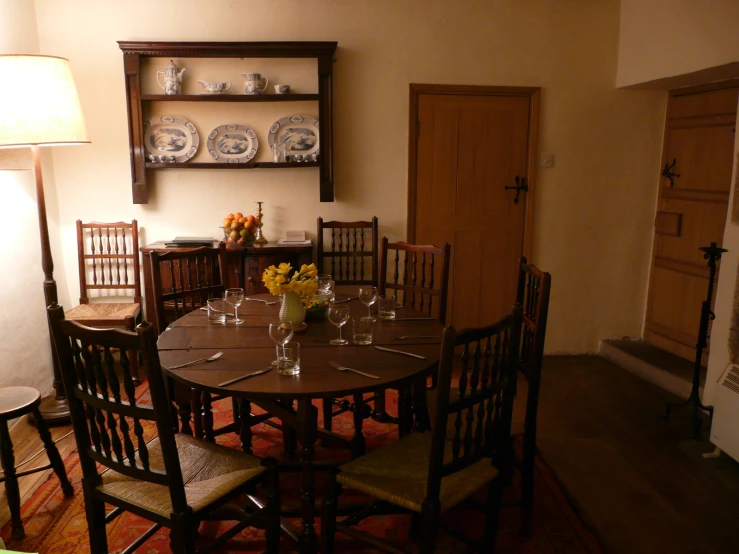 table with chairs, vases and plates on shelves