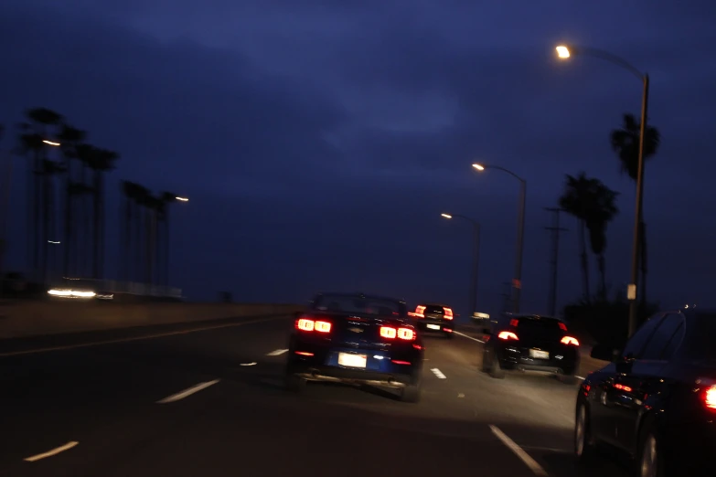 two cars driving on the road at night