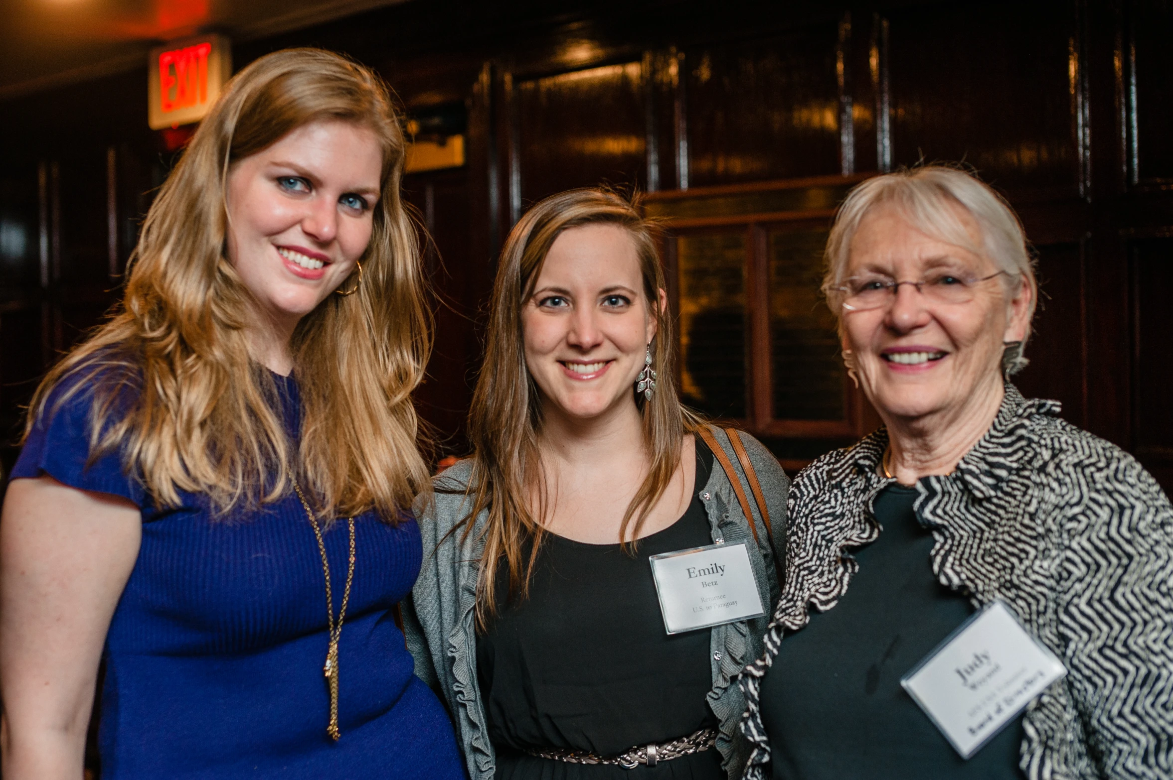 two women and an older woman smiling in a room