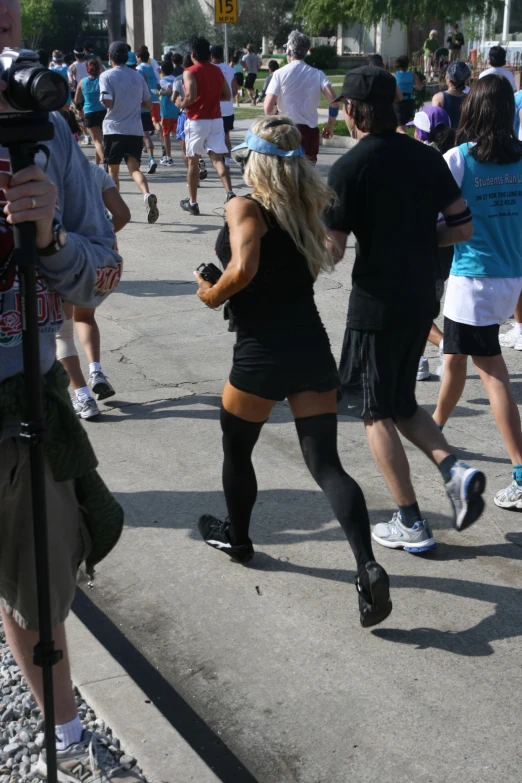 a woman in short skirt and knee high socks dancing outside