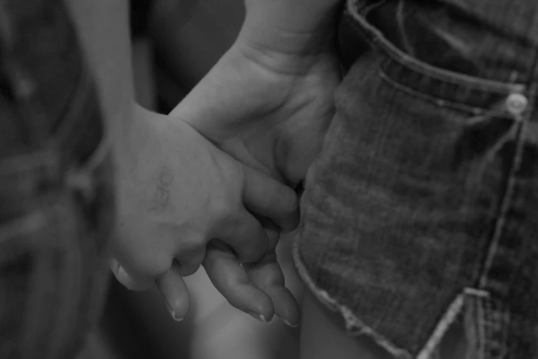 black and white image of two people holding hands