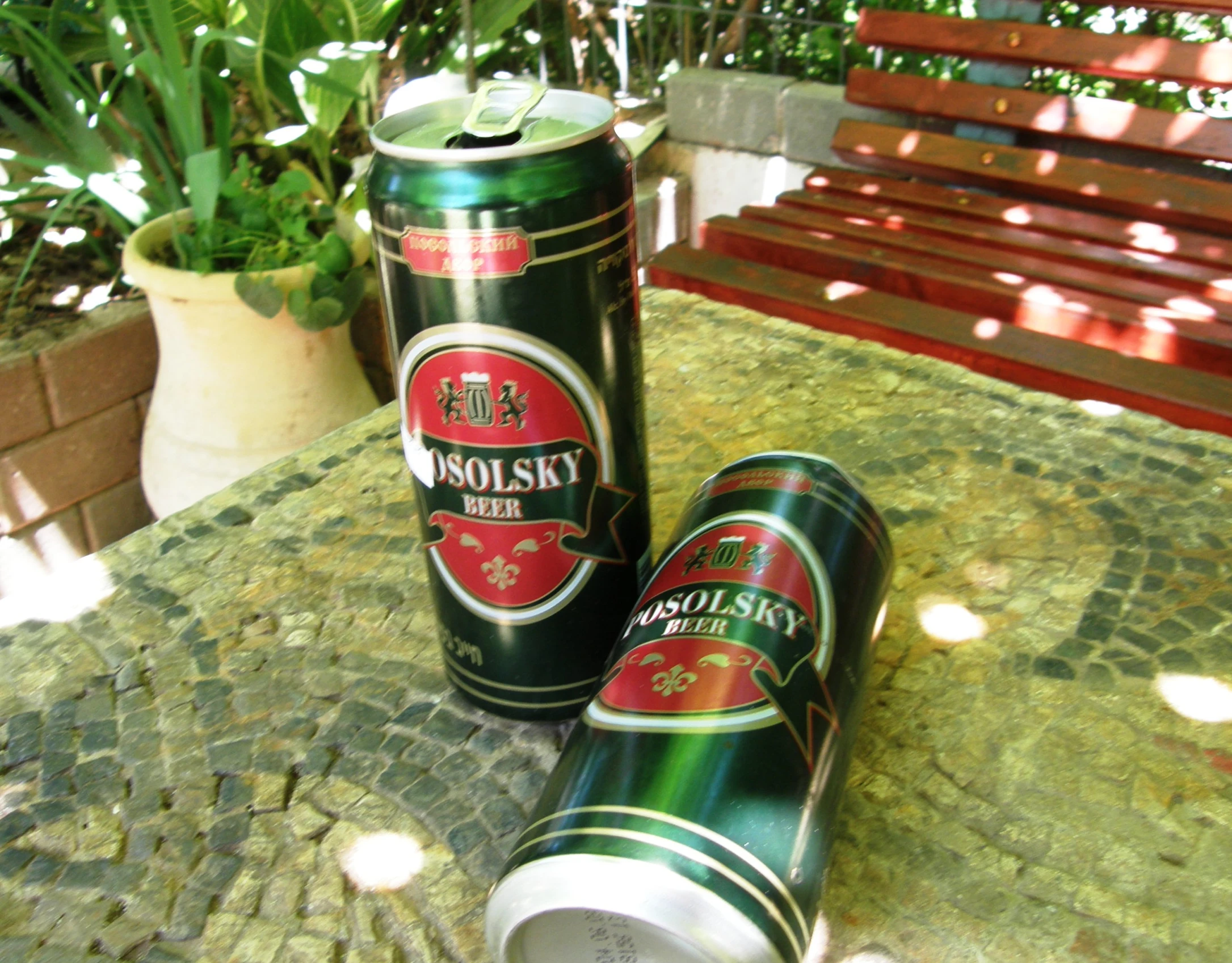 two cans of beer sitting on a table