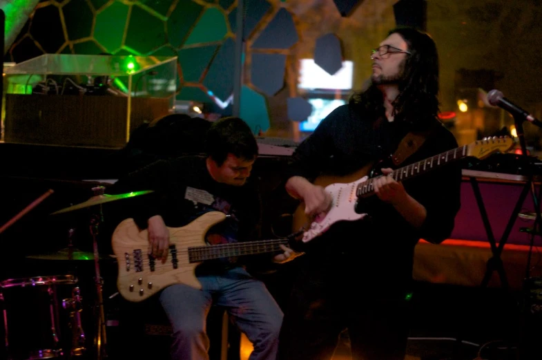 a man that is sitting down with a guitar