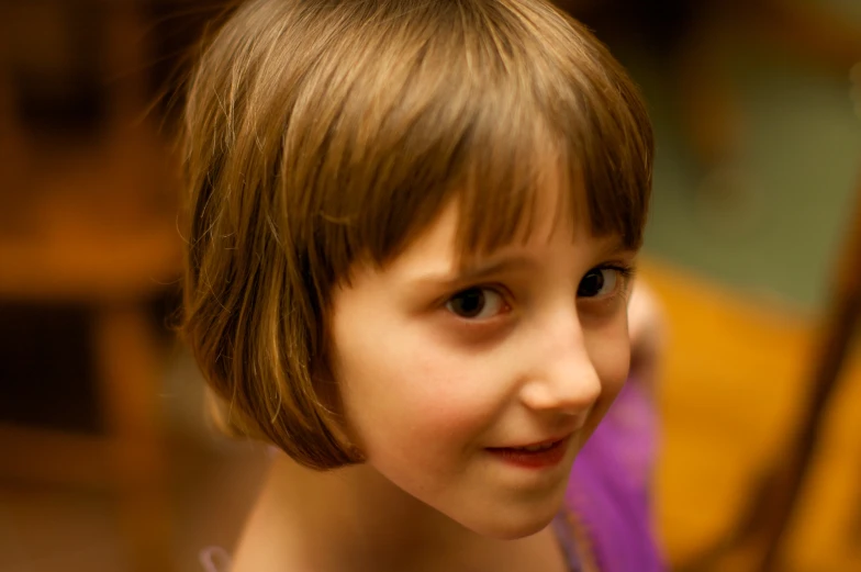 a little girl smiling with a tooth brush in her hand