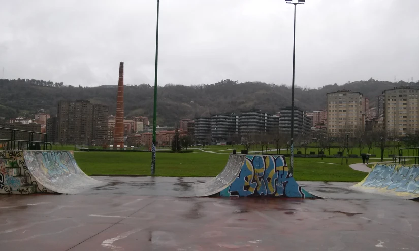 three skateboard ramps with different designs painted on them