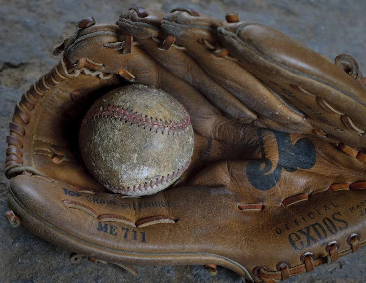 a baseball mitt and ball inside of it