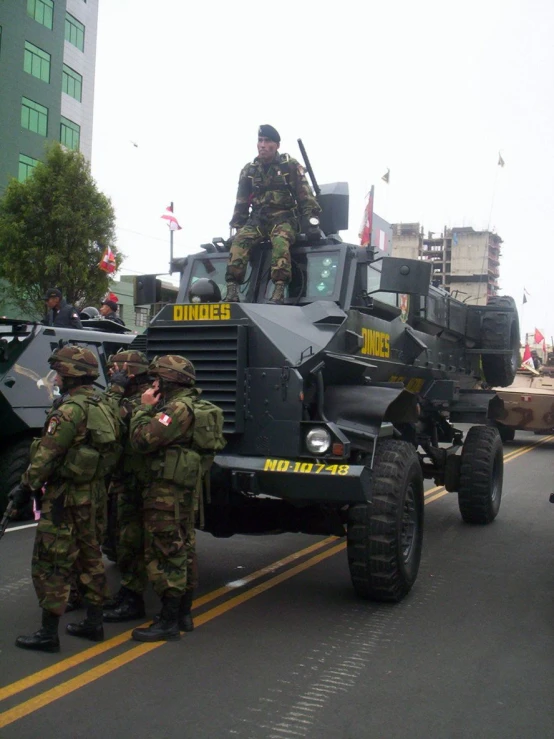 military men with their vehicles in the road