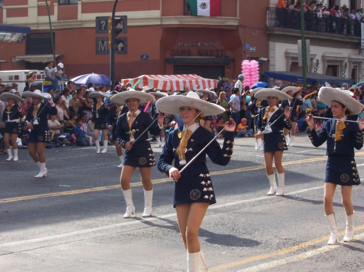 there are some women dressed in all kinds of costumes marching down the street