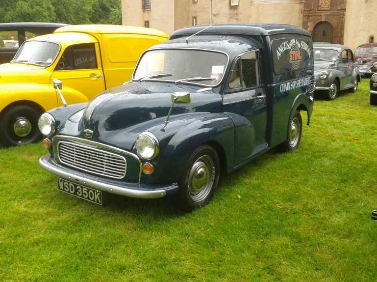 various types of cars parked outside on the grass