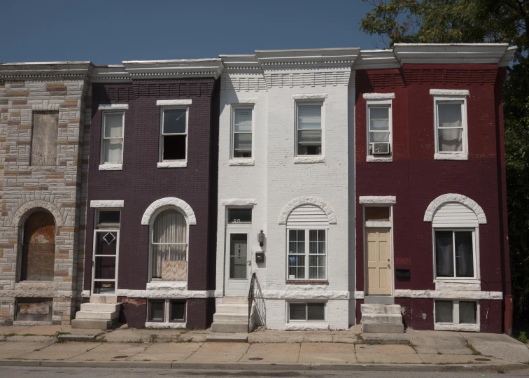 several brick town houses sit on either side of a street