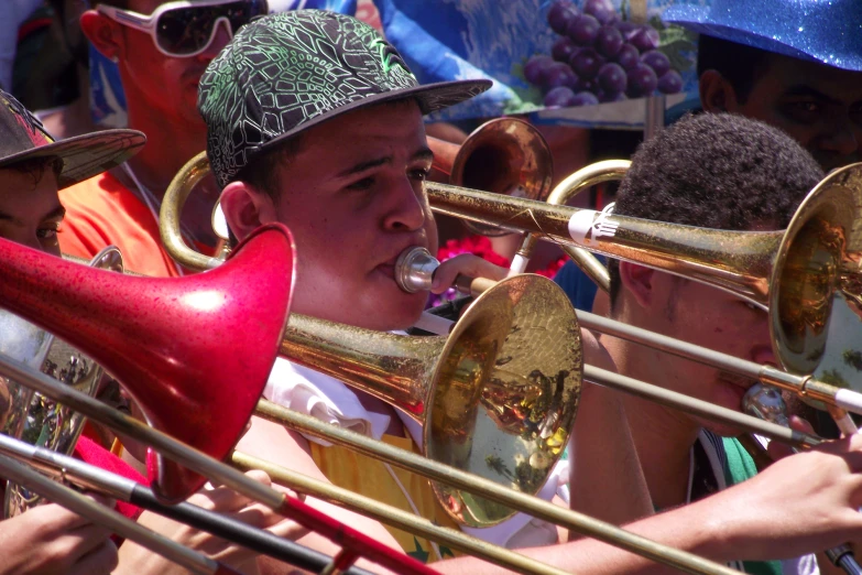 an orchestra member holding a trombone in his mouth