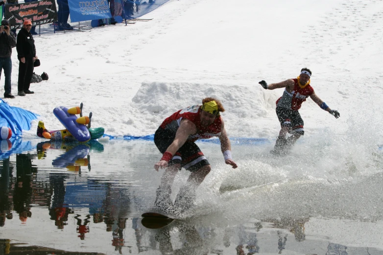 two snow skiers sliding down the snow on their skis