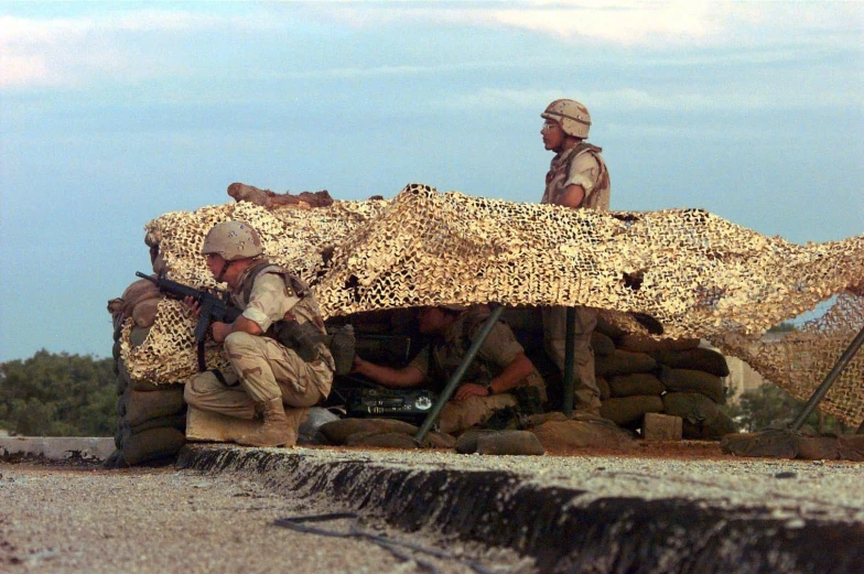 soldiers stand on top of a building under a covering