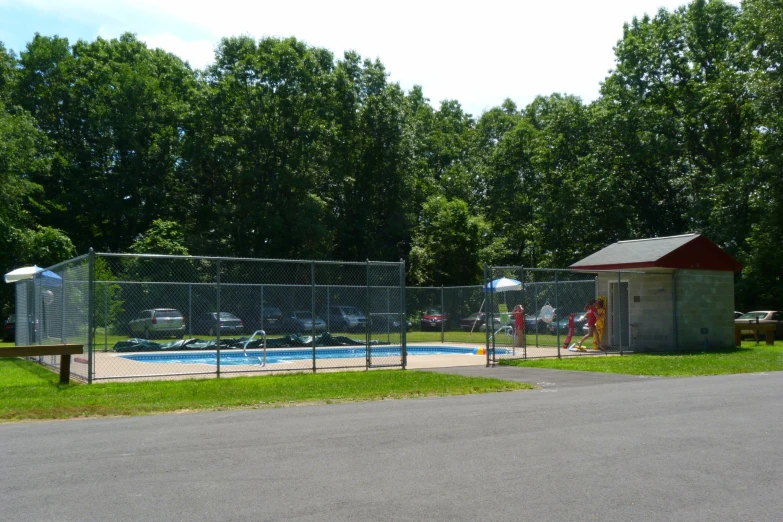 there is a park with several different pools next to a fenced pool