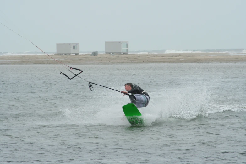 man water skiing on the side of a big body of water