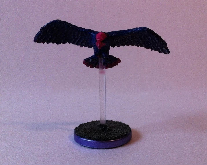 a toy bird with a black head and legs